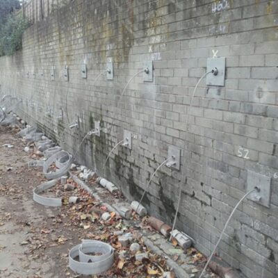 Platipus Platidrain in retaining wall Retaining wall stabilisation anchors post tensioning, awaiting trimming and completion. Lower anchors have the Platidrain system installed via a slot in the load plate.
